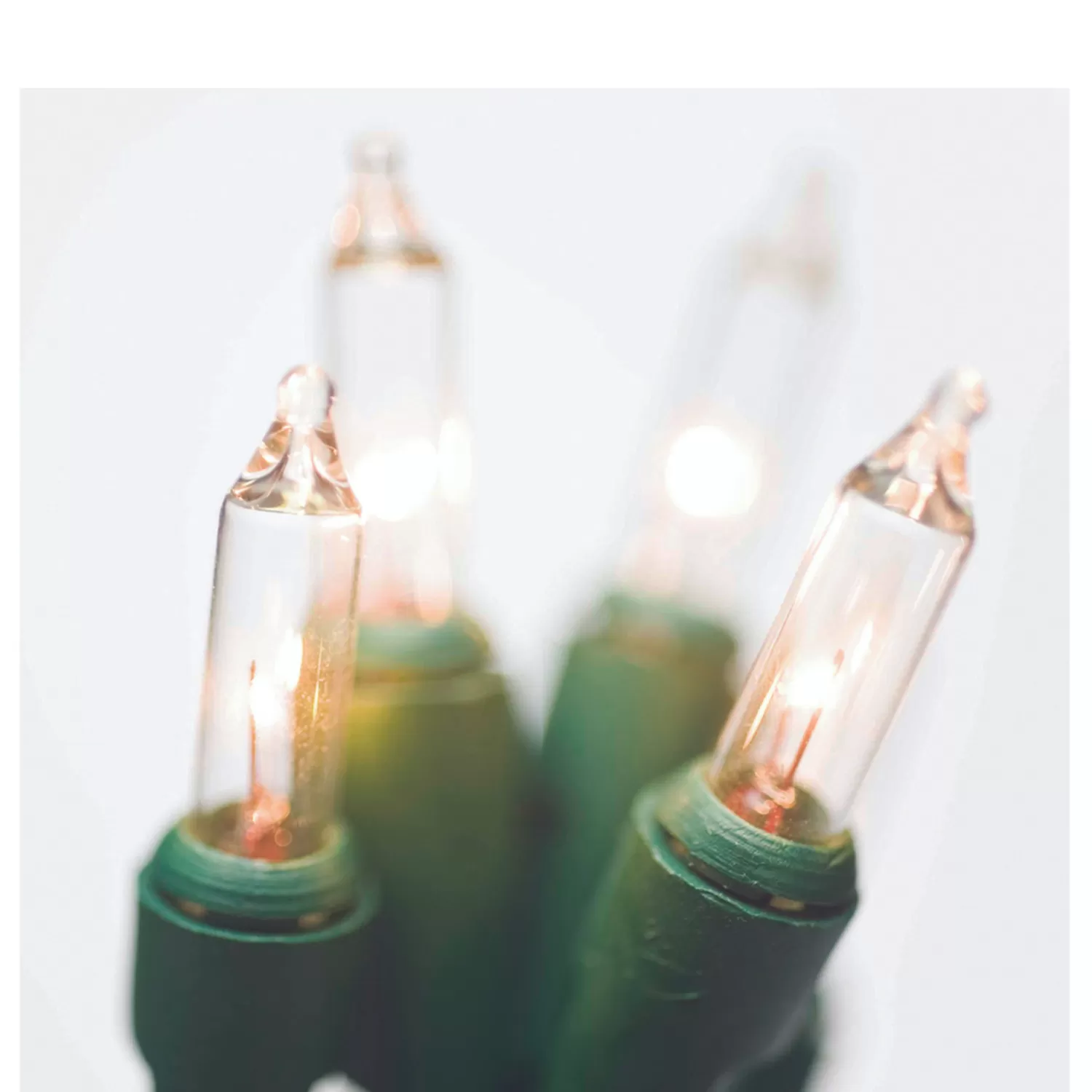 The Jolly Christmas Shop Mini Bulb Lights | Incandescent Lights | Brite Star 25' 100 LT Random Twinkling Clear Mini Incandescent Lights On Green 37-491-00